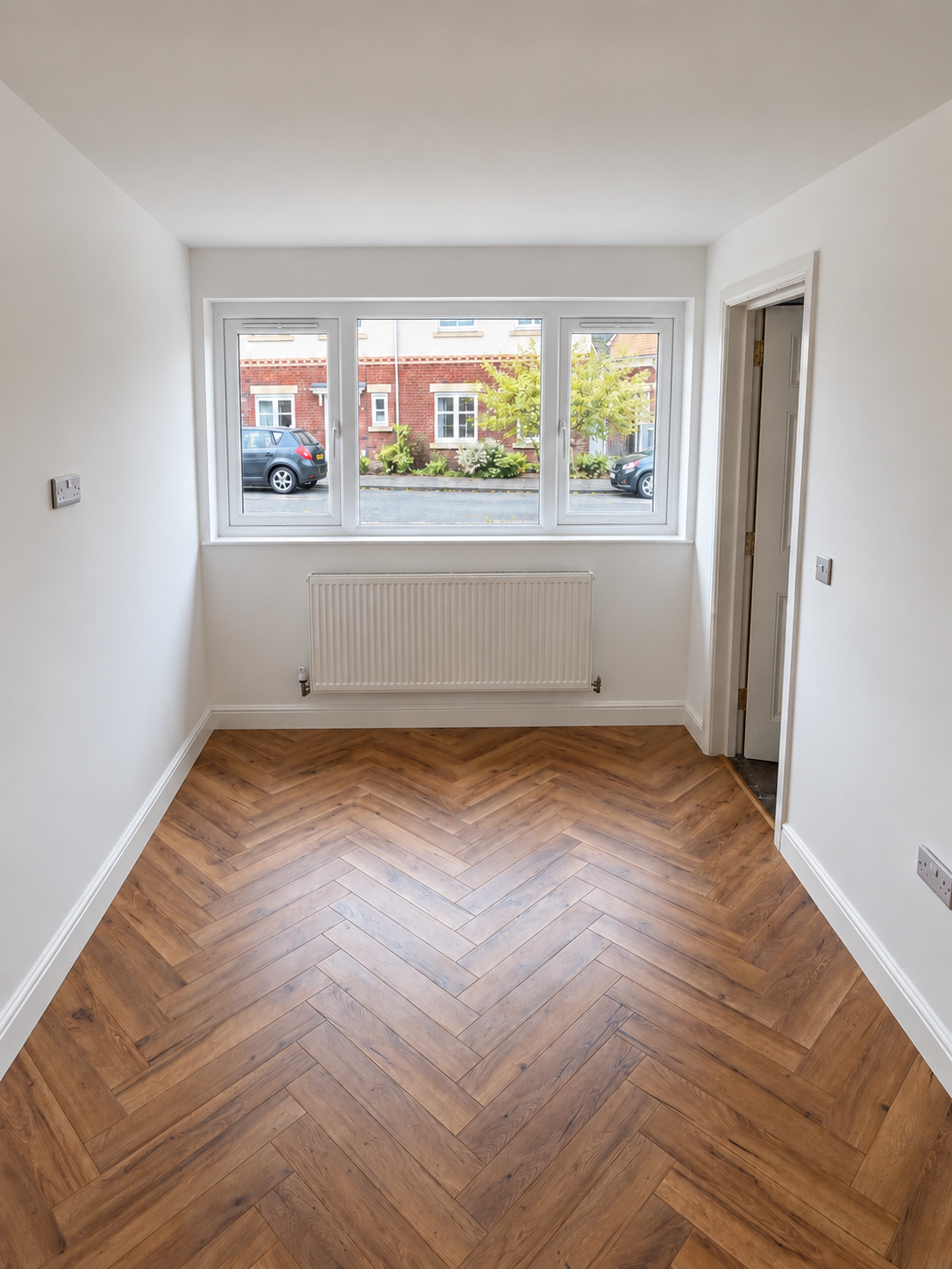 Finished garage conversion interior with white window